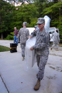 SFC Larry Long, 3BN/1BDE, carries  a new mattress donated by the GSDF.
