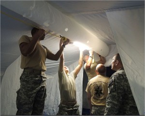 Georgia State Defense Force Soldiers install lighting in the mobile medical hospital as a part of their training during this exercise, Aug. 13, 2016, at Kennesaw State University's Marietta campus in Marietta, Ga. (Georgia State Defense Force photo by Chief Warrant Officer 2 Clunie)