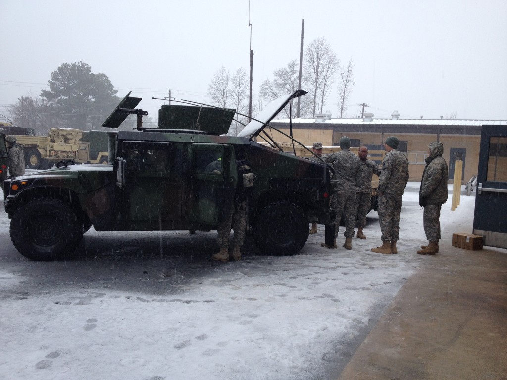 GSDF and National Guard troops loading a HMMWV with water and MRE’s.