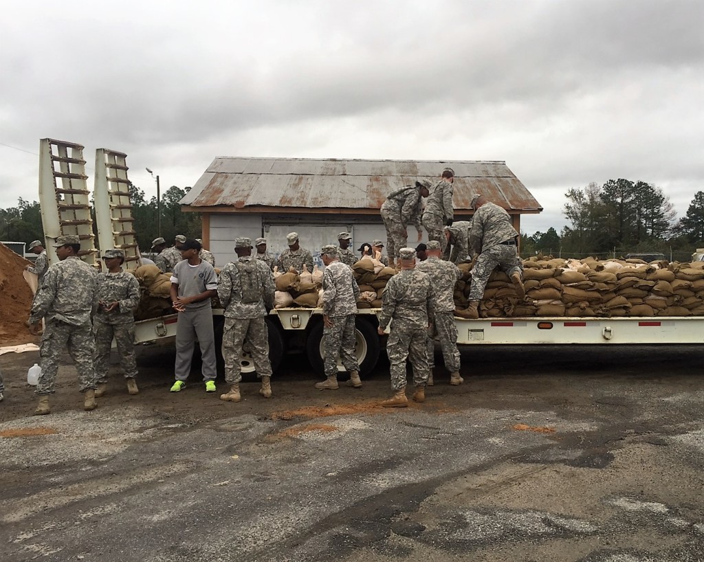 Georgia Army National Guard and Georgia State Defense Force Soldiers work together to load sandbags onto a flatbed truck as part of hurricane relief efforts near Augusta, Georgia. (Georgia State Defense Force photo by Chief Warrant Officer 2 W. Kevin Ward, 1BDE, AS3.)