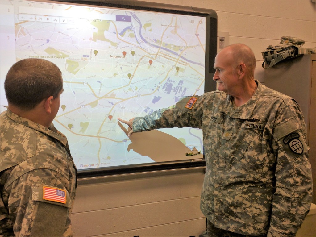 Maj. Ward (right) points out a shelter location to Staff Sgt. Blalock (left) in the Tactical Operations Center at Tubman Education Center in Augusta, Georgia on October 9, 2016. (Georgia State Defense Force photo by 2nd Lt. Hughes)