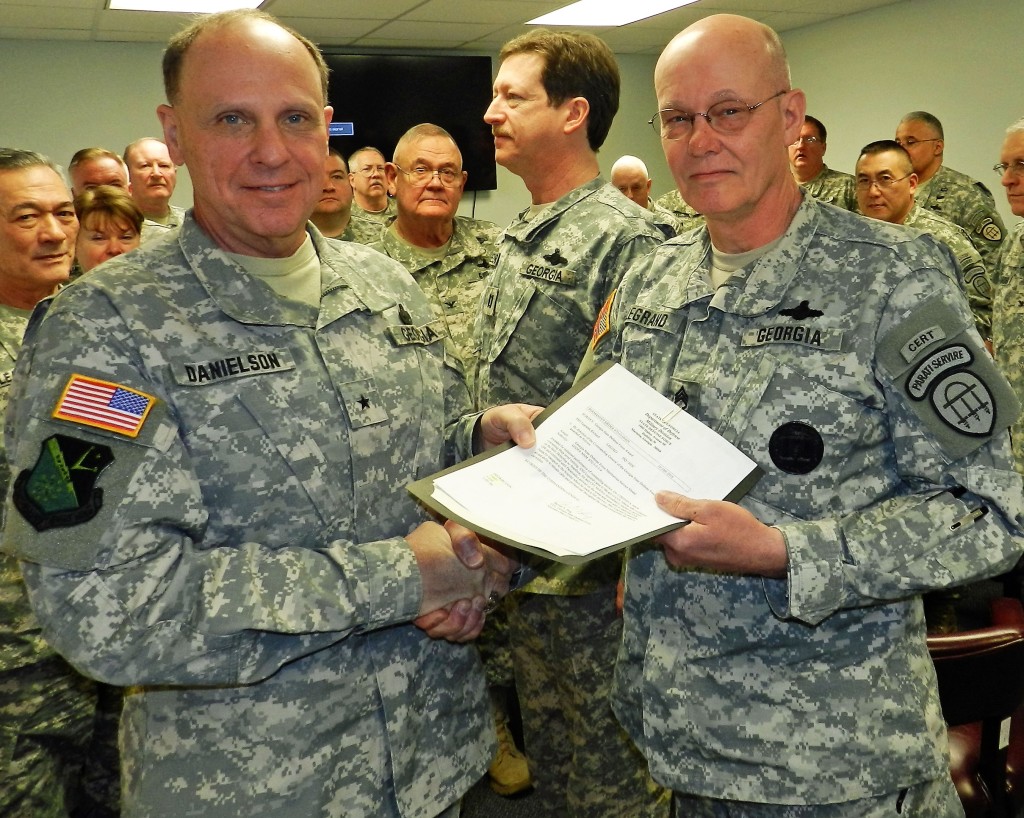 Brig. Gen. Tom Danielson, GSDF commander, presents the Georgia State Defense Force Meritorious Service Medal to Staff Sgt. Richard Legrand. Georgia State Defense Force photo.