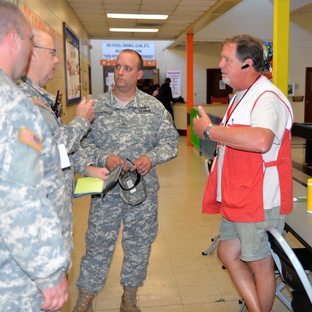 Members of the Georgia State Defense Force coordinate with a member of the American Red Cross at the East Macon Recreation Center in Macon, Georgia during the response to Hurricane Matthew on October 8, 2016. (Georgia State Defense Force photo by Sgt. 1st Class Alasa)