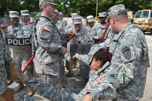 CPL Chris Treadwell assists in moving National Guard simulated casualty from the line.